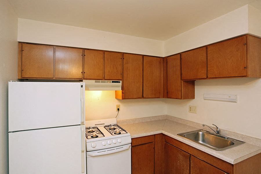 a kitchen with a stove refrigerator and a sink