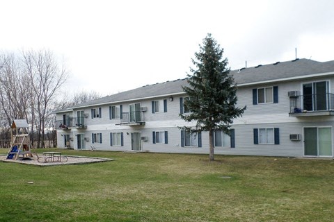 a large white house with a yard in front of it