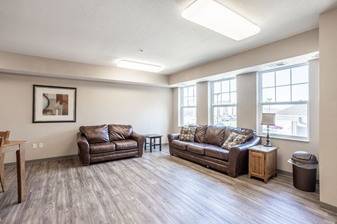 A living room with two couches and a wooden table.