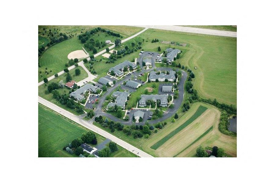an aerial view of a college campus with lawns and buildings
