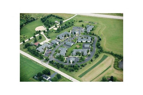 an aerial view of a college campus with lawns and buildings