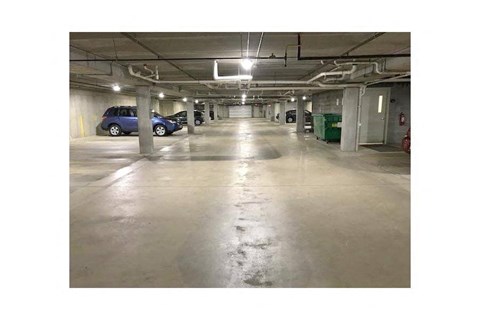 an empty parking garage with cars parked in it