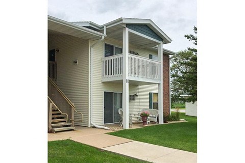 a white house with a porch and a staircase