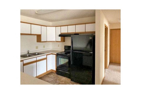 a kitchen with a black stove and a black refrigerator