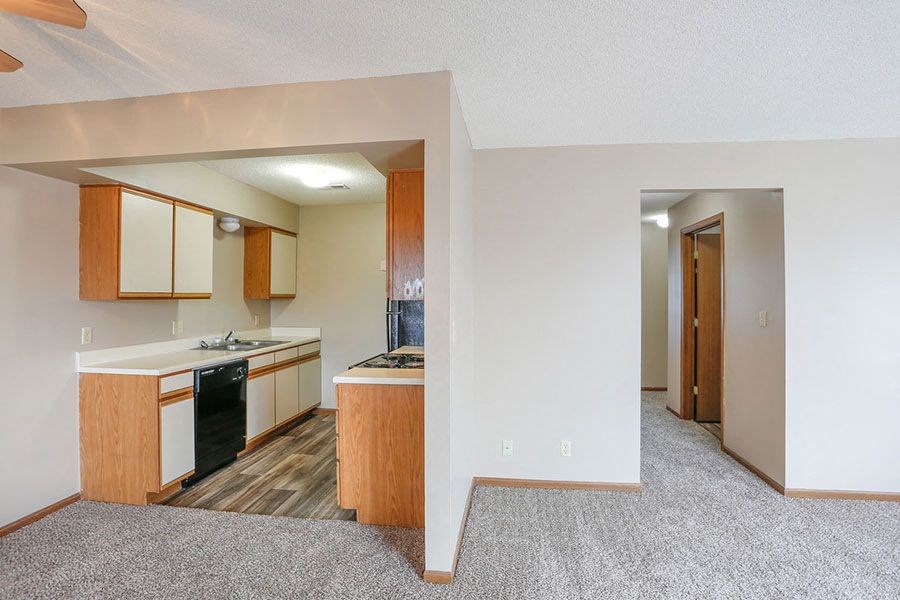 an empty kitchen with a stove and a sink
