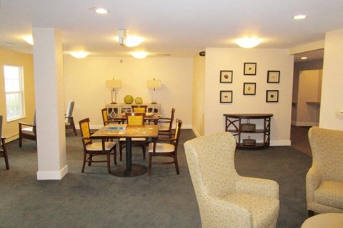 a living room and dining room with a table and chairs