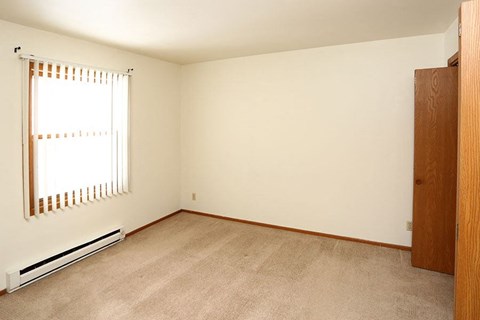 A room with a window and a door.