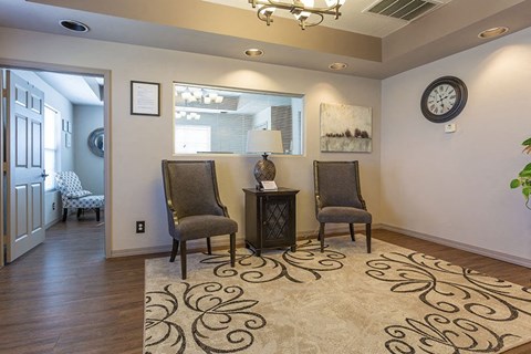 A living room with two chairs and a table.
