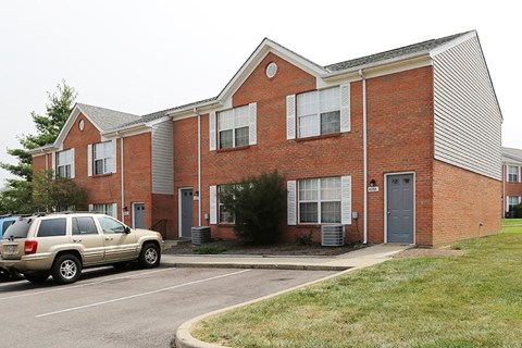 a car parked in front of a brick building