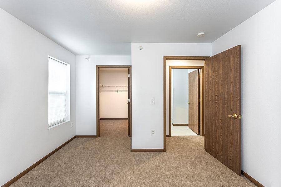 A room with a carpeted floor and white walls.