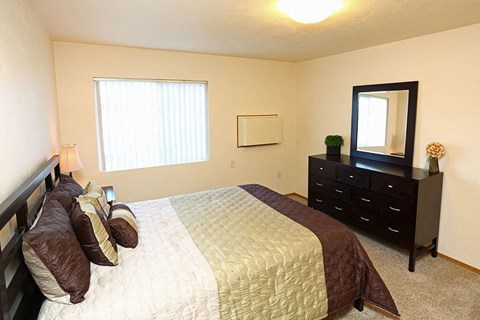 a bedroom with a bed and a dresser