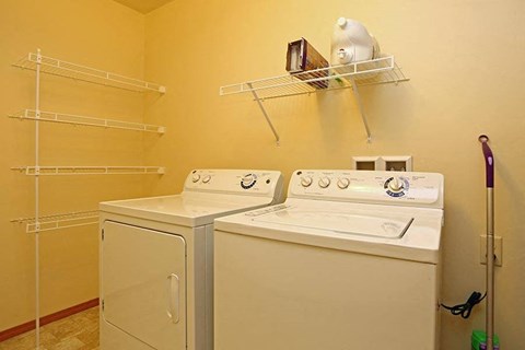 a room with two washes and a dryer in it