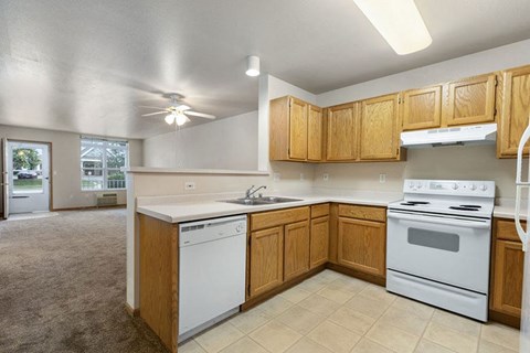 a kitchen with white appliances and wooden cabinets
