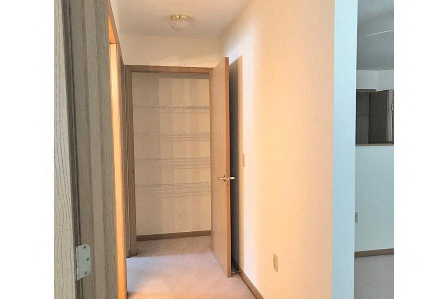 a hallway with an open door to a closet
