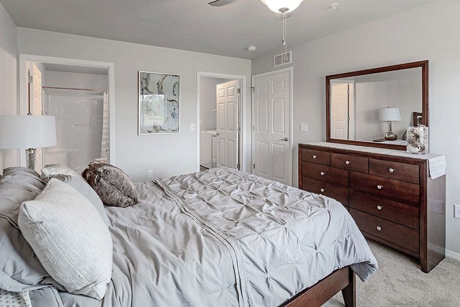 a bedroom with a bed and a dresser