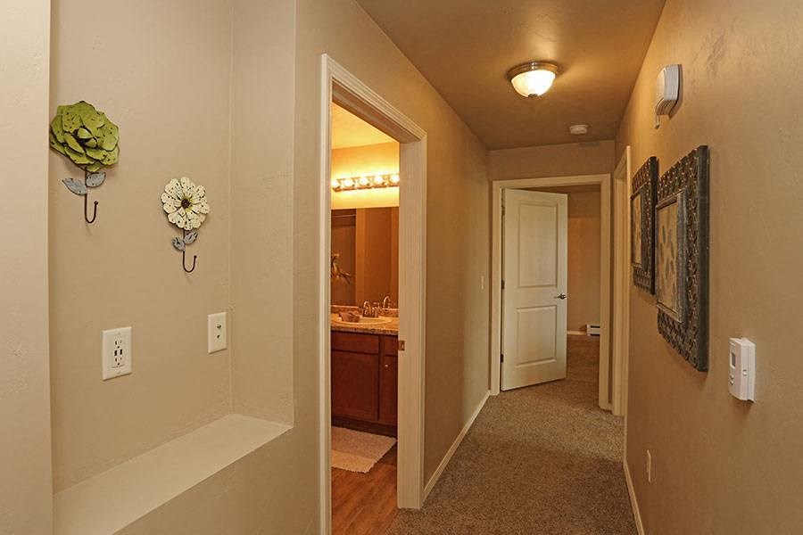 a hallway with a door to a bathroom