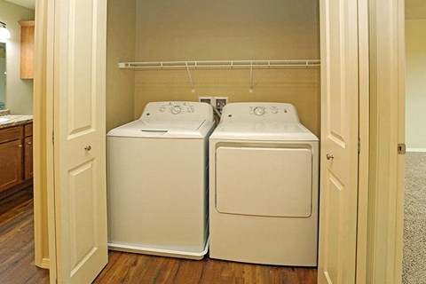 two washers and dryers in a laundry room