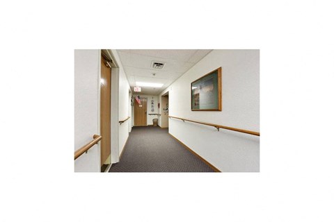 a hallway in a hospital with a painting on the wall