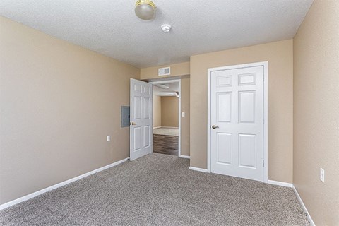 an empty living room with a white door
