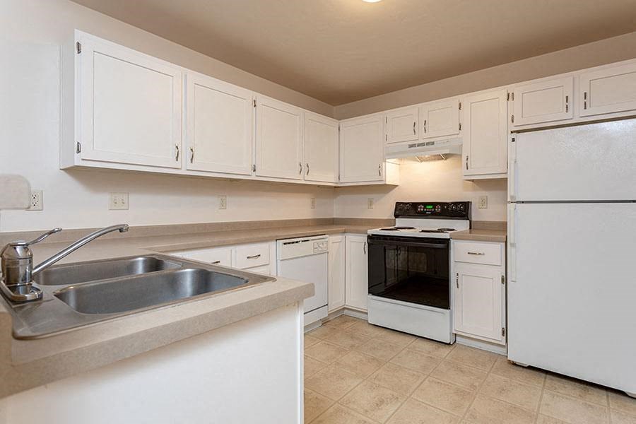 a kitchen with white cabinets and a sink
