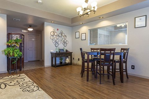 A dining room with a wooden table and chairs.