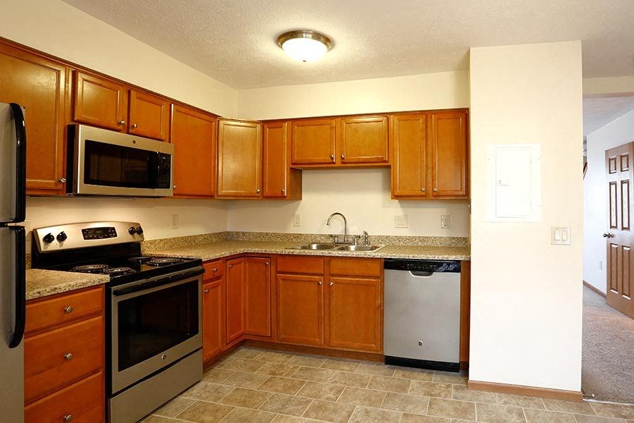 a kitchen with a stove and a sink and a microwave