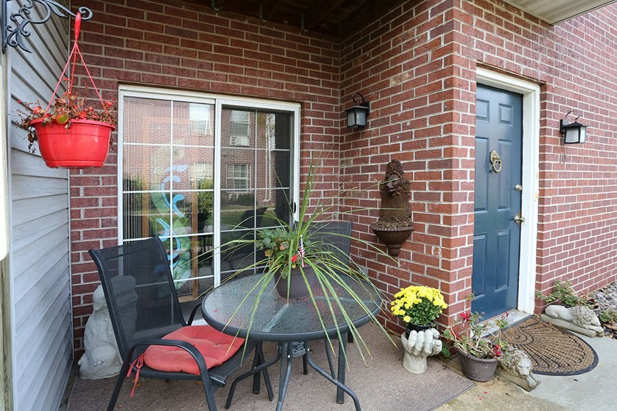 A small patio with a table and chairs.