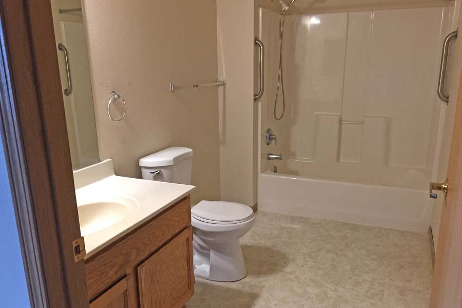 A bathroom with a toilet, sink, and bathtub.