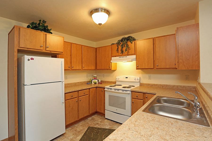 a kitchen with a stove refrigerator and a sink