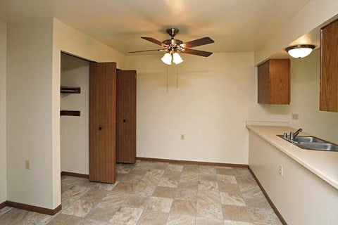 a kitchen with a ceiling fan and a sink