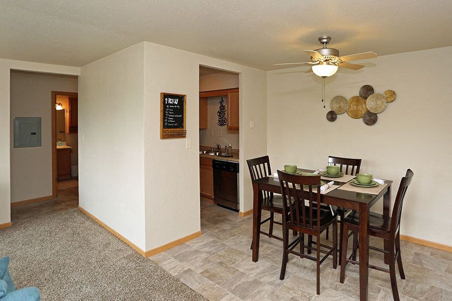 an empty dining room with a table and chairs