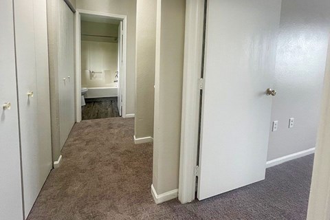 A small bedroom with a bed and a sink.