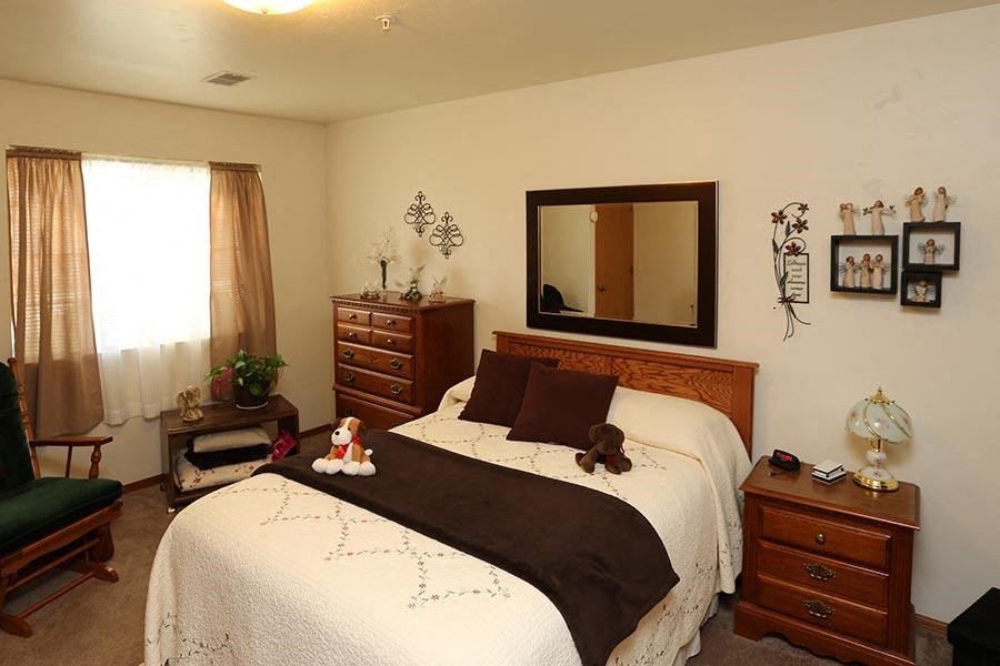 a bedroom with a bed and a mirror