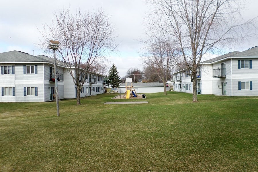 a group of houses in a yard with a playground
