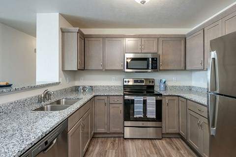 a kitchen with granite counter tops and stainless steel appliances