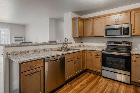 A kitchen with wooden cabinets and stainless steel appliances.