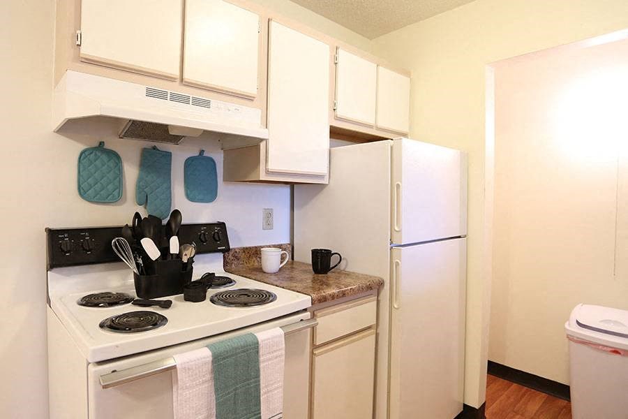 a kitchen with a stove and a refrigerator