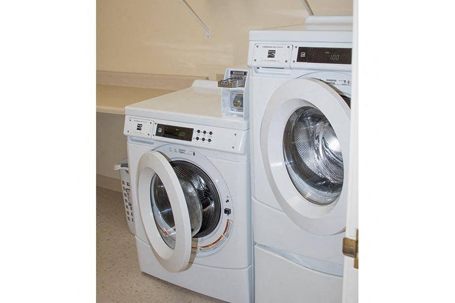 a washing machine and a dryer in a laundry room