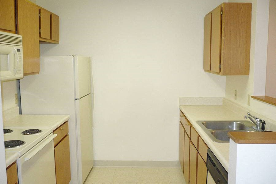 a kitchen with a stove and a sink and a refrigerator