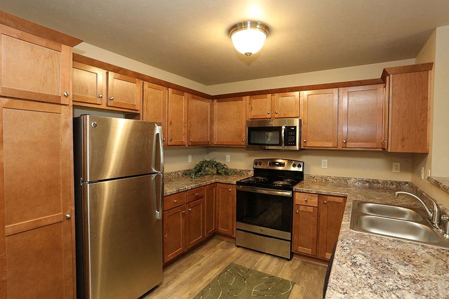 a kitchen with stainless steel appliances and wooden cabinets