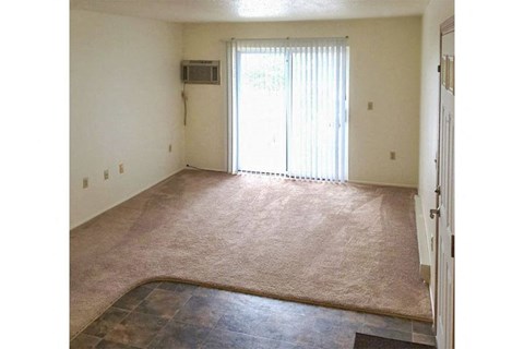 an empty living room with a sliding glass door