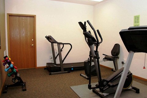 a gym with exercise equipment in a small room