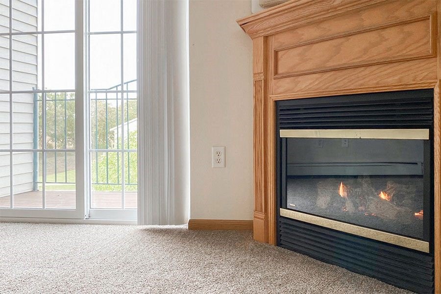 a living room with a fireplace and a sliding glass door