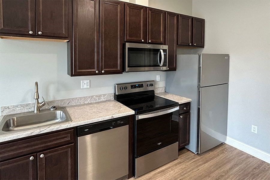 a kitchen with stainless steel appliances and wooden cabinets