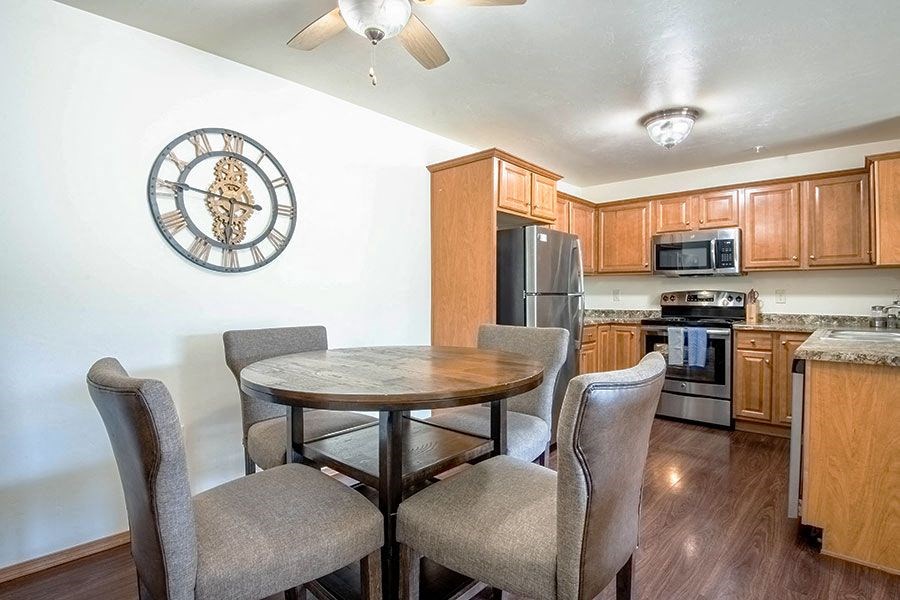a kitchen and dining room with a table and chairs