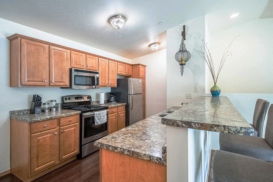 a kitchen with granite counter tops and stainless steel appliances
