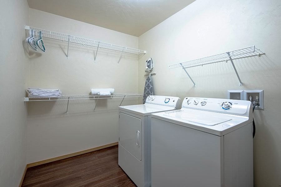 a laundry room with two washes and a dryer