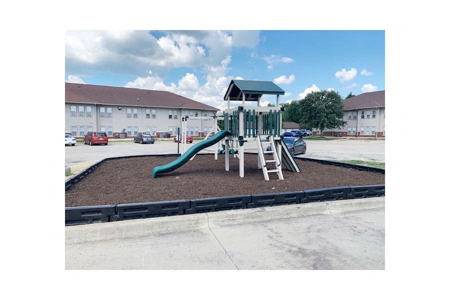 a playground with a jungle gym and a slide