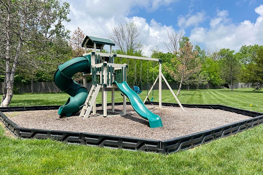 a playground with a slide and a swing set