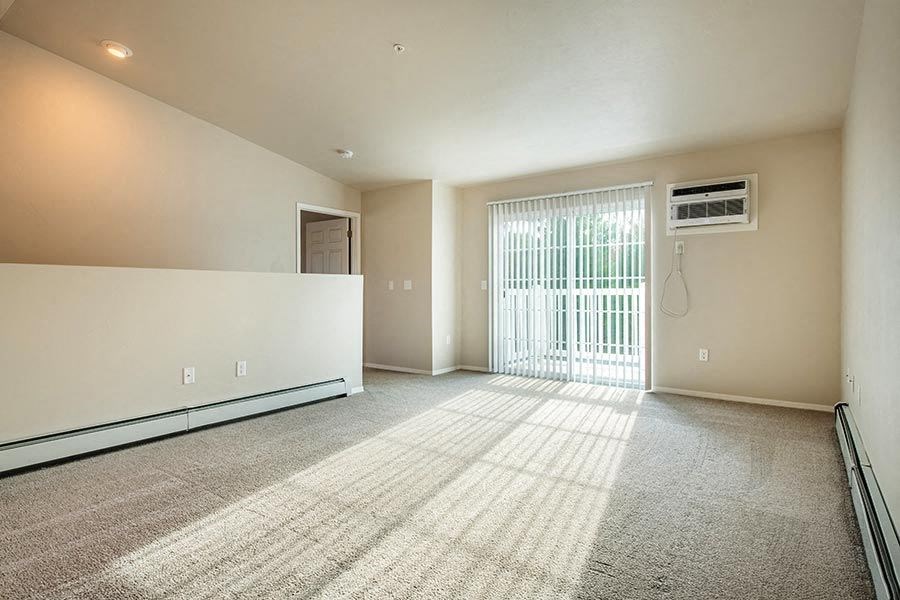 an empty room with a bathroom and a shower